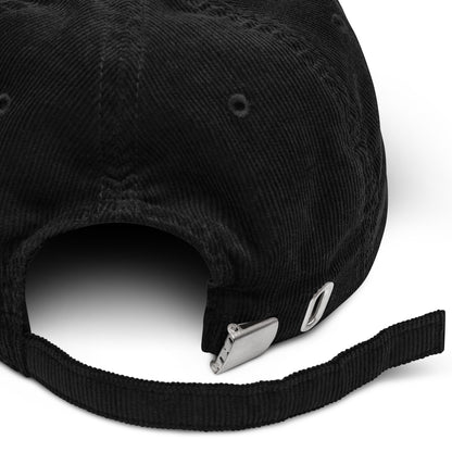 A black corduroy 21mil cap with embroidered logo.